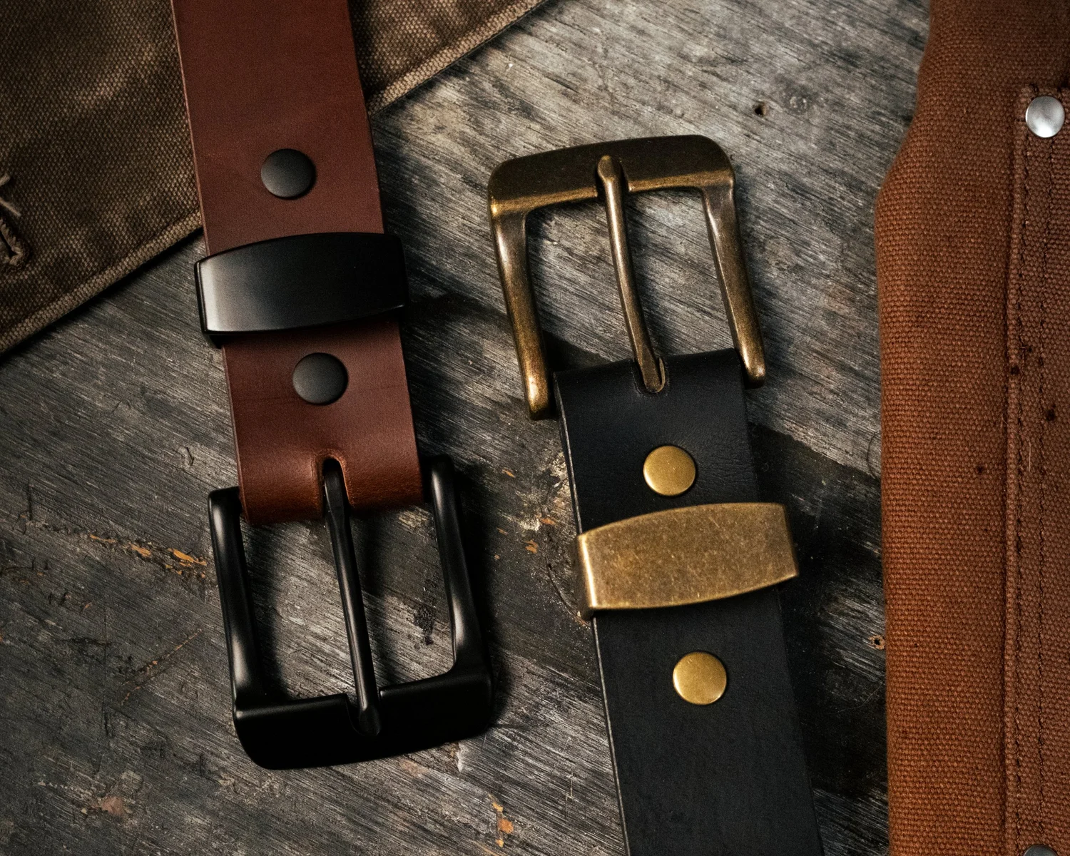 Buffalo leather belts in black and brown with brass and blacked-out buckles